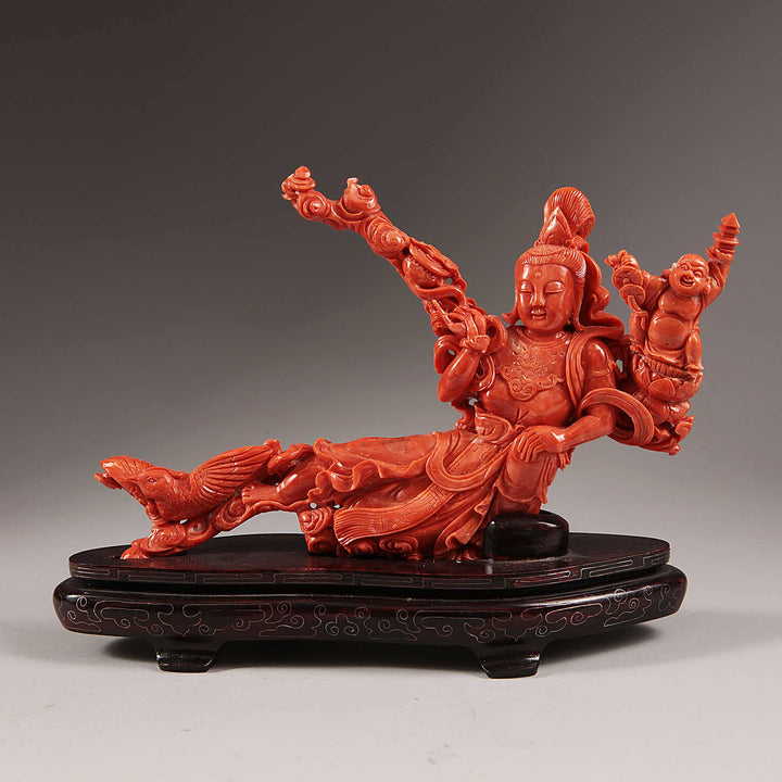 Chinese carved precious coral reclining Guanyin with attendants on wooden base by Nwtiques