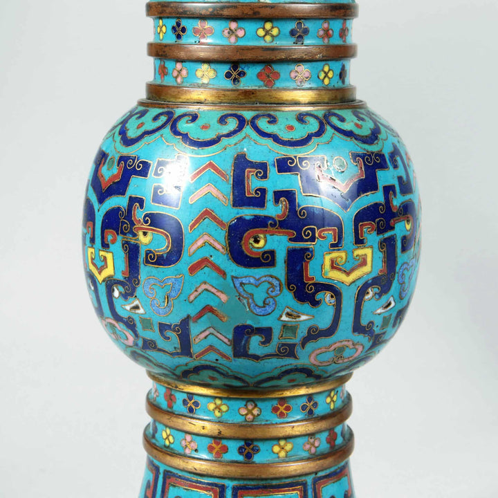 Close-up of 19th century Qing Dynasty blue cloisonne Gu vase with intricate enamel patterns by Nwtiques