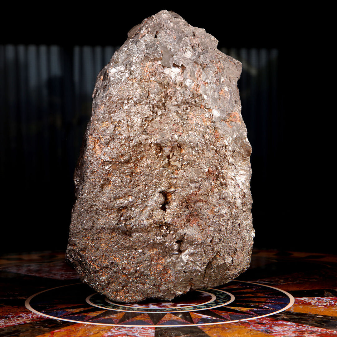 Pyrite specimen by Collection CK10 showcasing a glittering, textured surface on an artistic circular base.