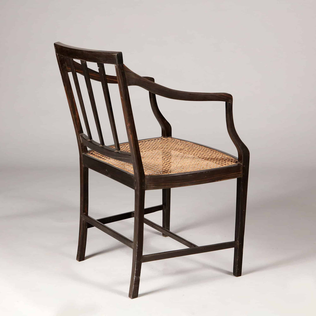 Solid ebony Anglo Indian dining chair with caned seat and spindle back from Collection EE30