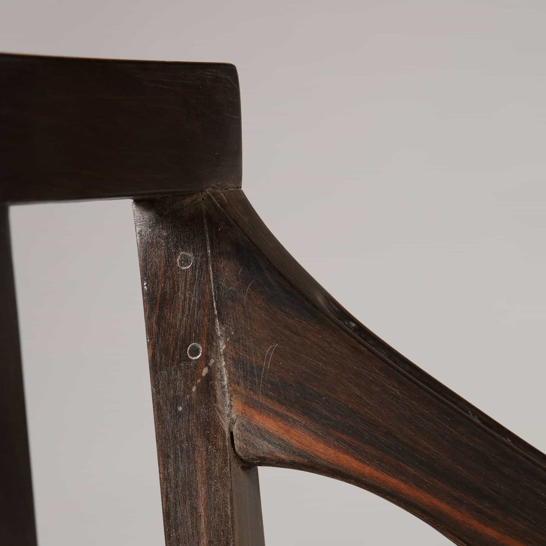 Close-up detail of solid ebony wood frame from Collection EE30 12-piece Anglo Indian dining chair set with caned seats