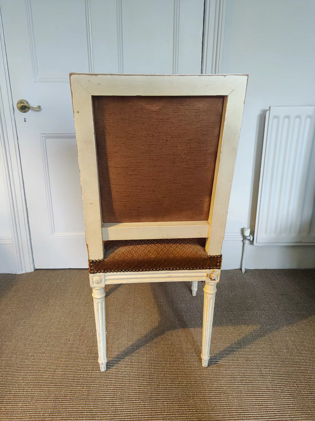 Rear view of a white painted Louis XVI side chair with original upholstery, offered by Nwtiques