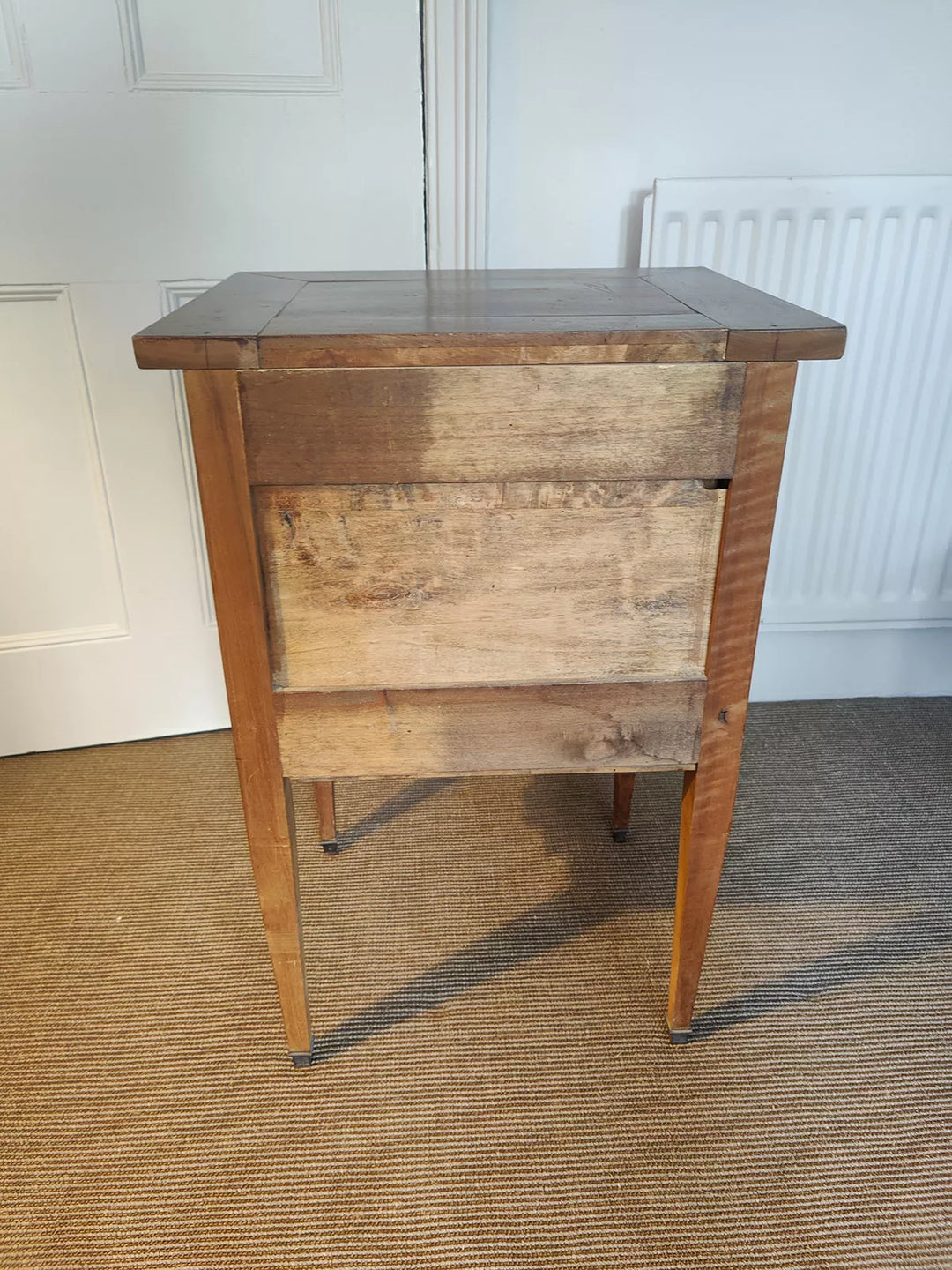 Side view of a 19th century walnut side cabinet with tapered legs by Nwtiques