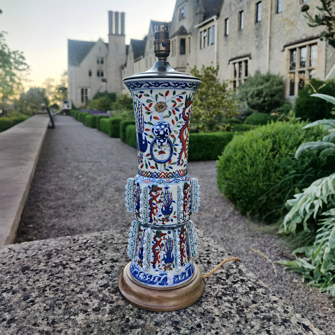 Samson Vase Mounted as a Table Lamp with blue and red bird and floral porcelain on wooden base outdoors