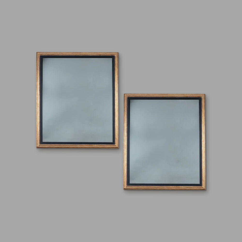 Pair of Burnished Giltwood Wall Mirrors, on a plain mid-grey background.