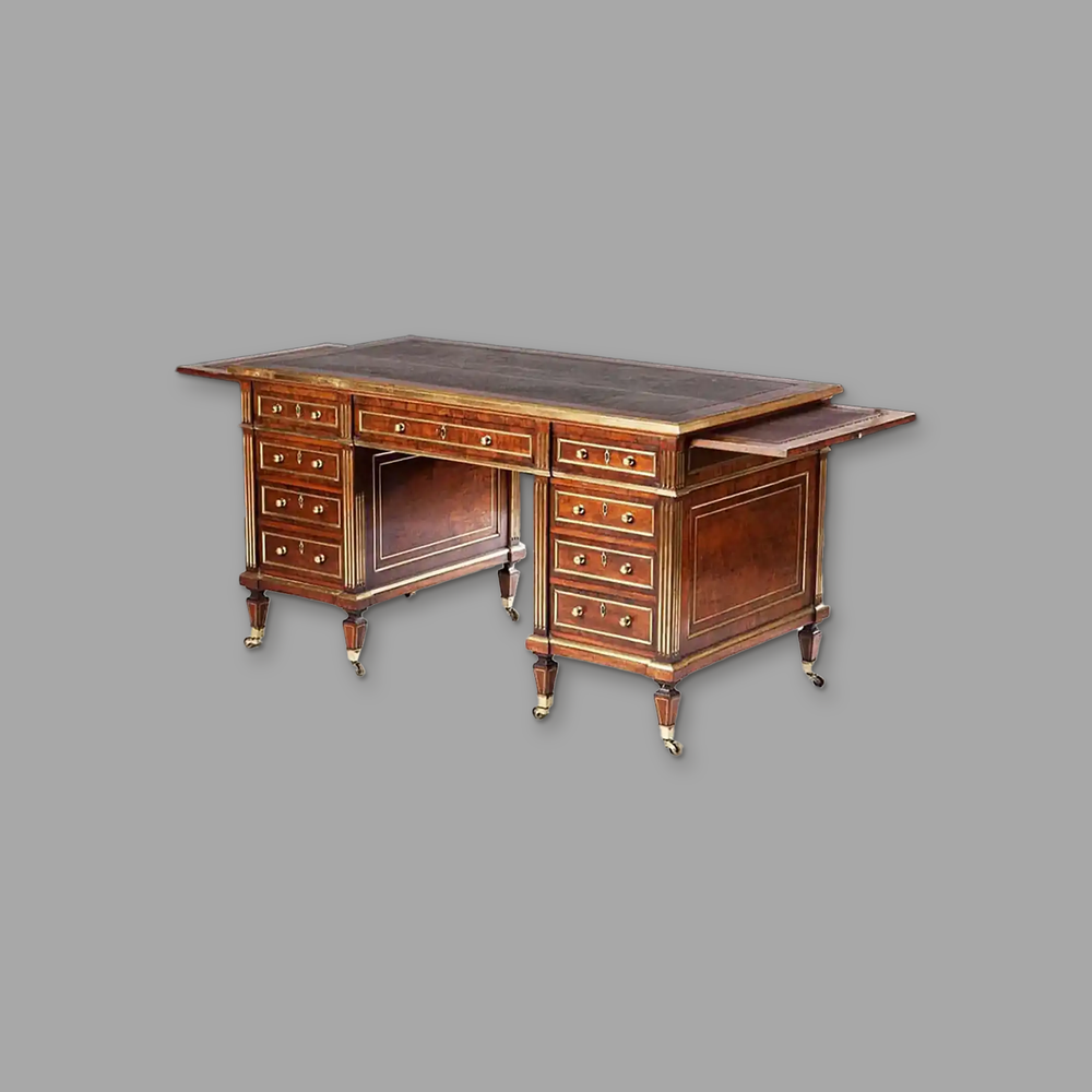 Rich Plum Pudding Mahogany and Brass Bound Pedestal Desk, on a plain mid-grey background.