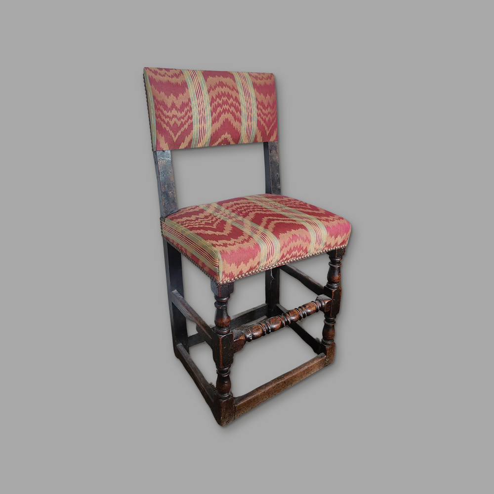 17th Century Oak Hall Chair, on a plain mid-grey background.