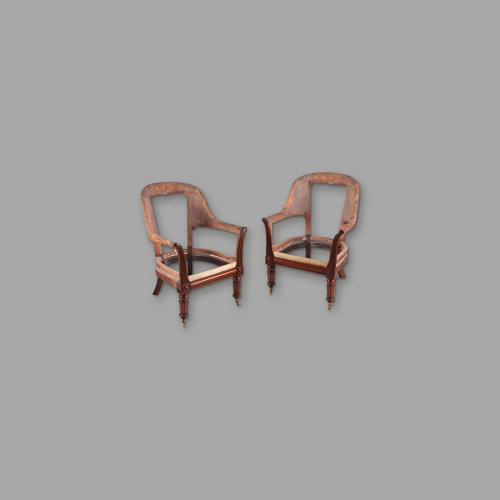 Pair of William IV Library Armchairs, on a plain mid-grey background.