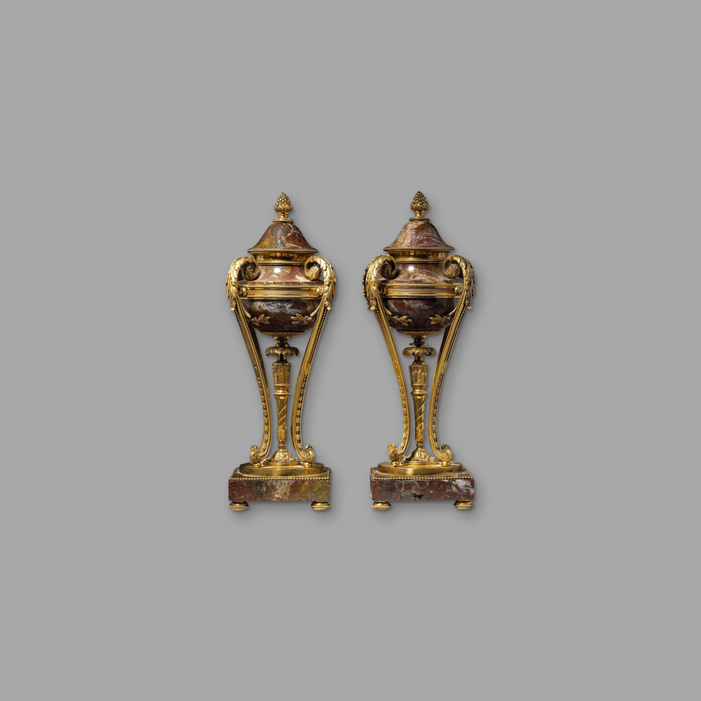 Pair of Sicilian Red Jasper Covered Gilt Bronze Urns, on a plain mid-grey background.