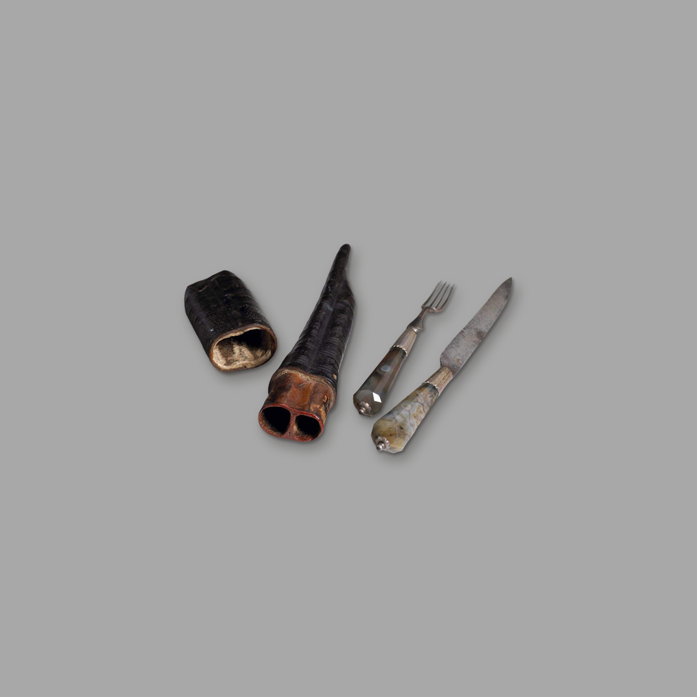 Two-piece cutlery with agate handles, on a plain mid-grey background.
