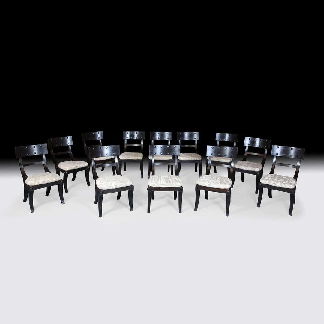 Set of 12 Ebony Klismos Dining Chairs with handmade horsehair cushions from Collection EE30 displayed in elegant arrangement