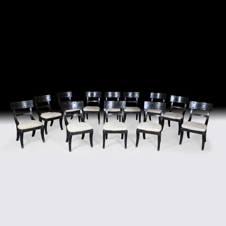 Set of 12 Ebony Klismos Dining Chairs with handmade horsehair cushions from Collection EE30 displayed in elegant arrangement