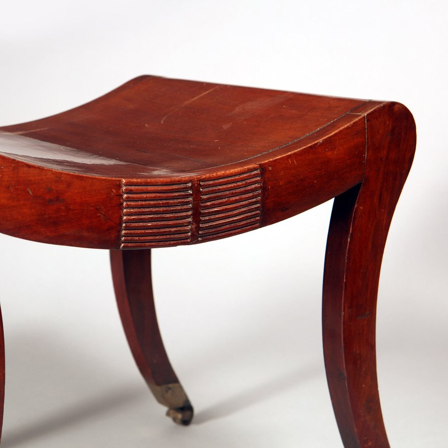 Regency mahogany sabre legged saddle stool with carved details from Collection TH10 in polished finish
