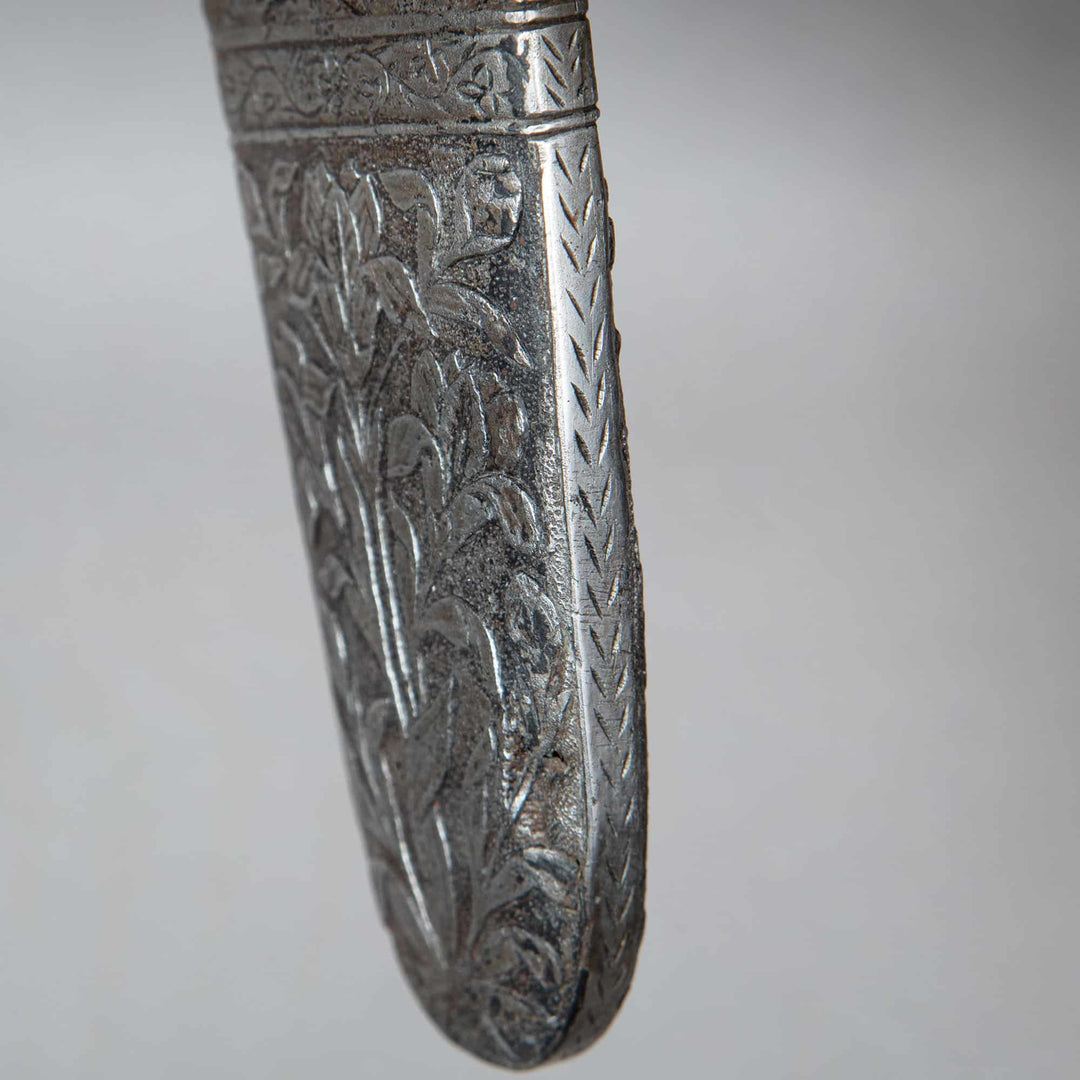A finely carved 17th-century Mughal steel chape with foliate designs, from Nwtiques.
