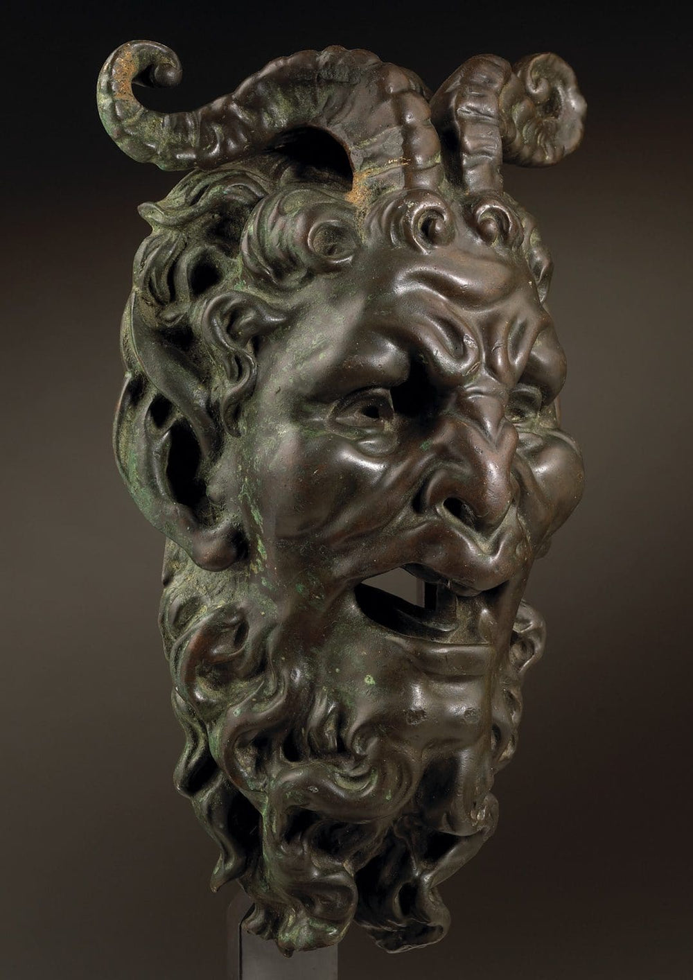 Bronze mask of a Satyr Fountain Head with curled horns and detailed facial features, patinated bronze, Italy circa 1800.
