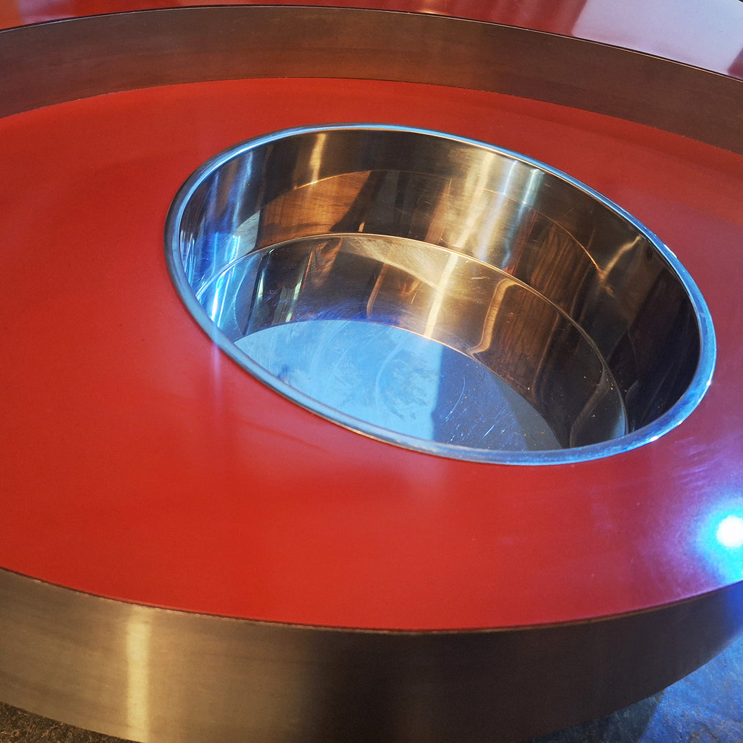 Close-up of TRG red and brushed steel coffee table by Willy Rizzo from Nwtiques showcasing bold circular design