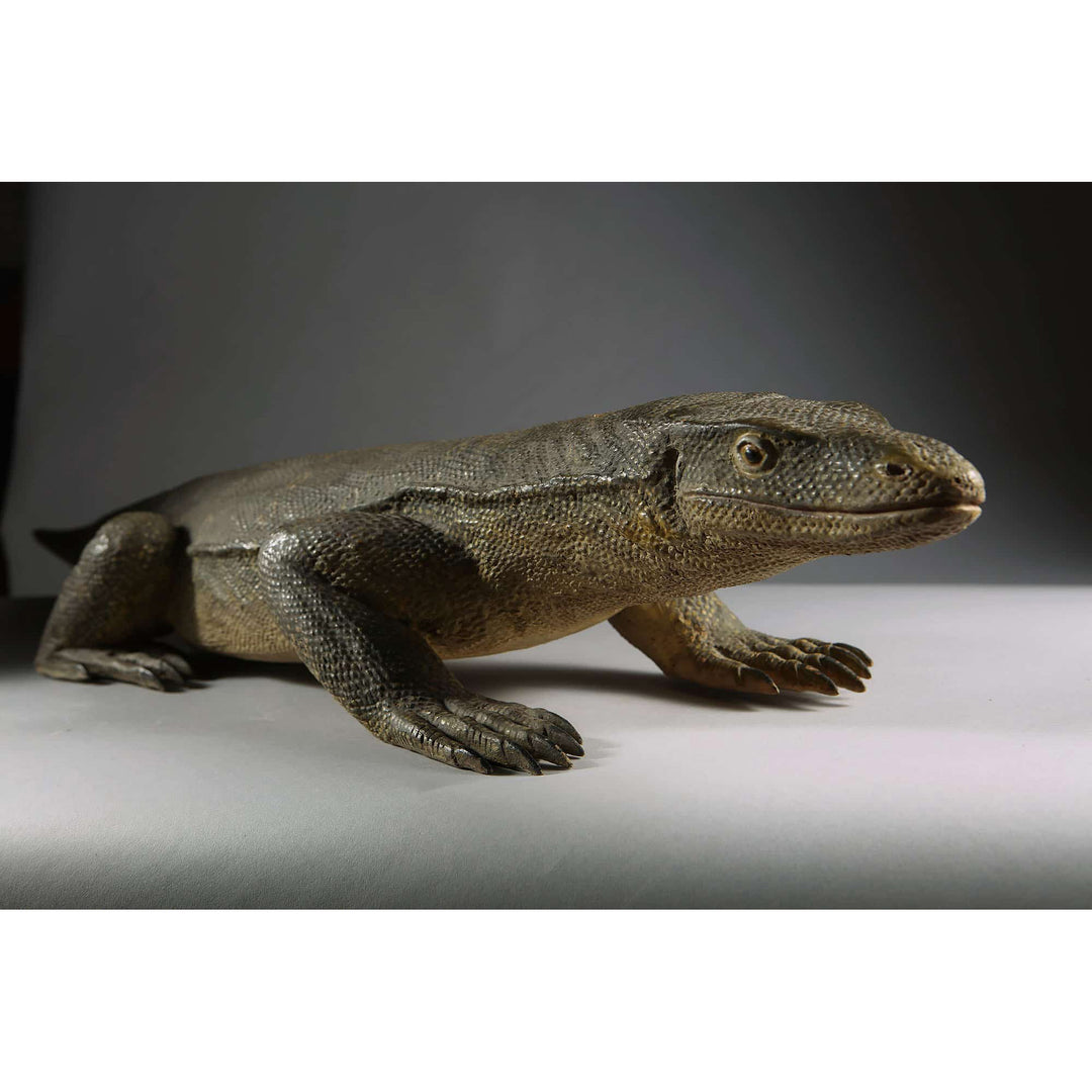 Carved wooden Komodo dragon figure with lifelike texture by Nwtiques, Indonesia, early 20th century.
