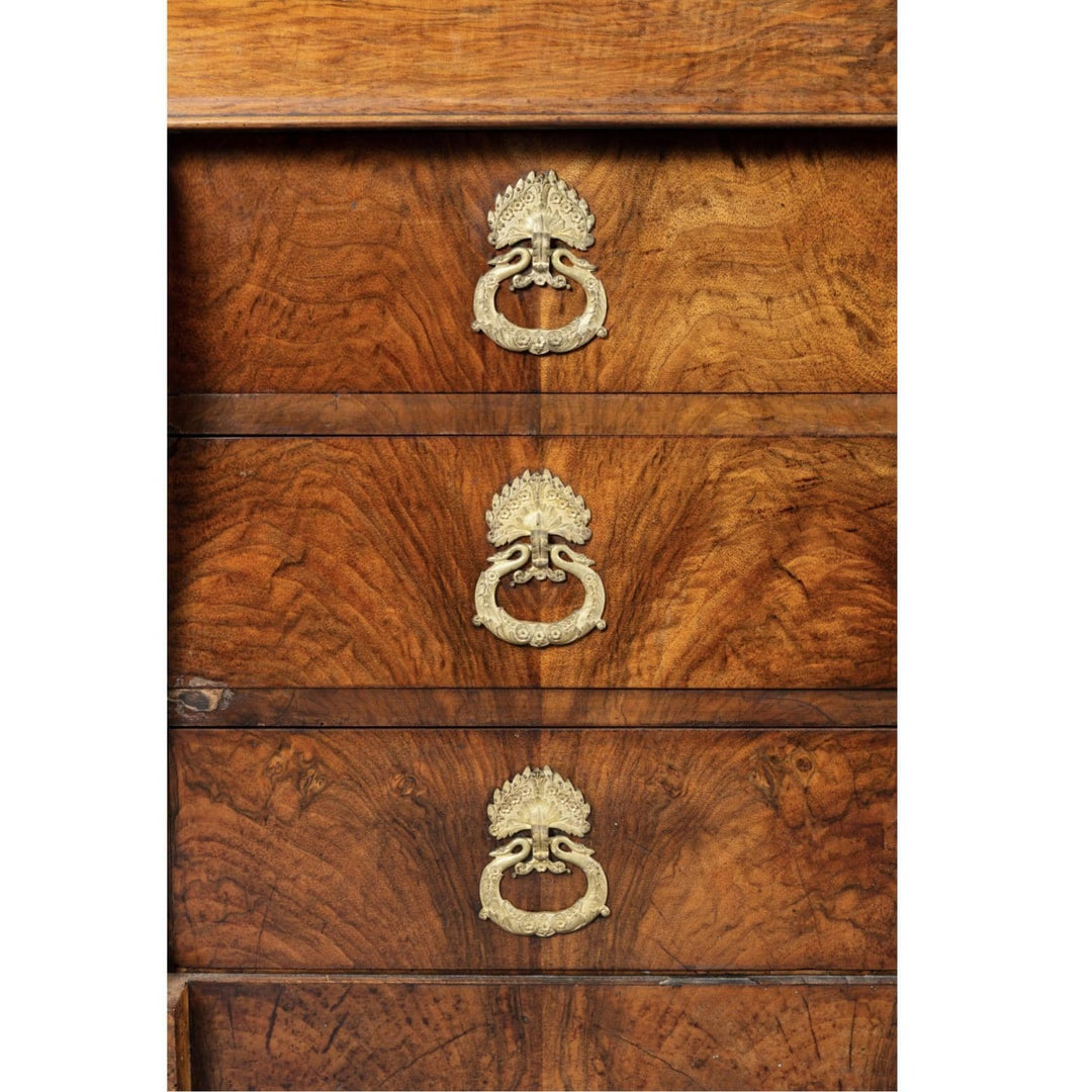 Close-up of Louis Philippe figured walnut commode drawer handles by Nwtiques with intricate gilt drop details
