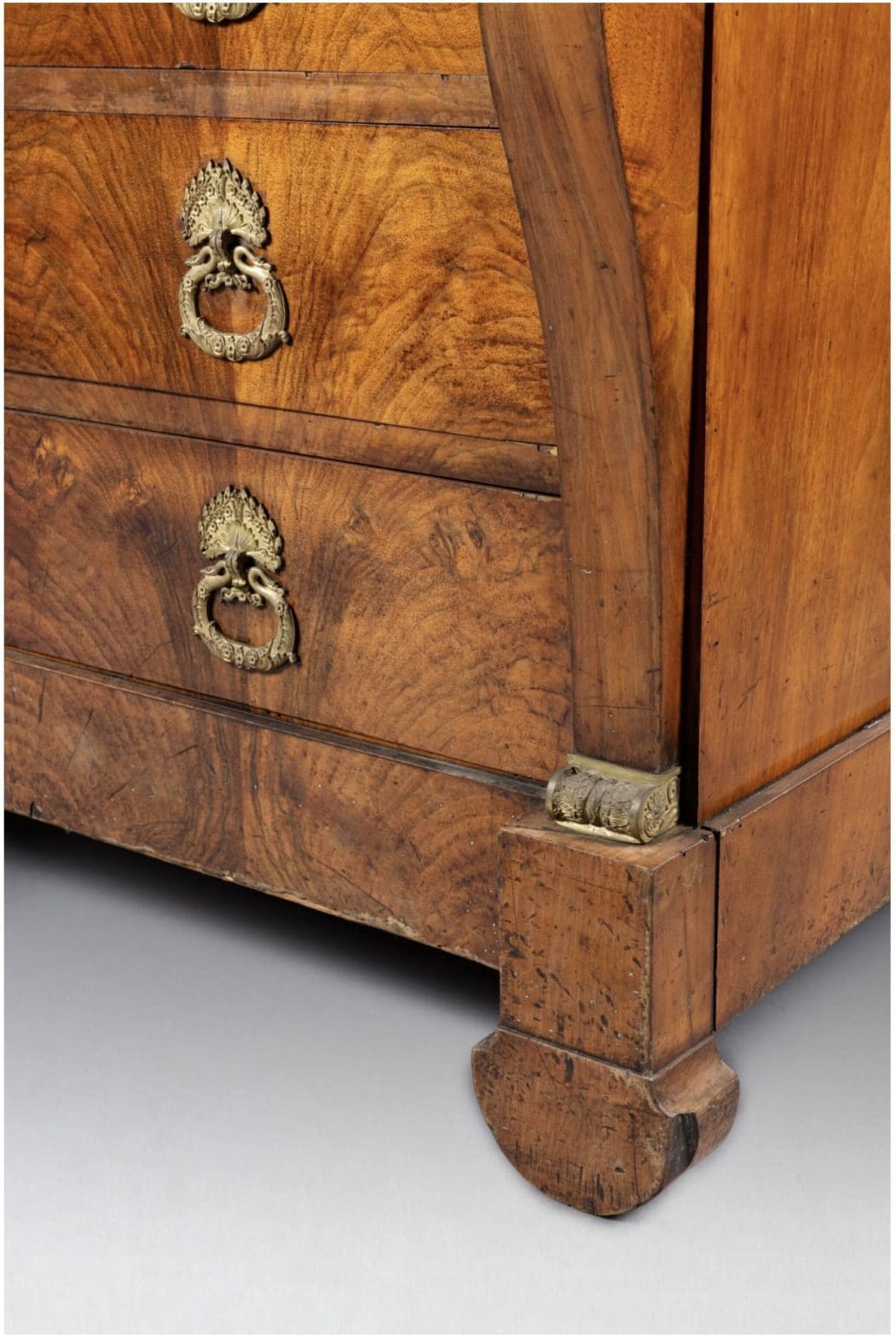 Close-up of figured walnut drawer fronts and ornate gilt handles on Louis Philippe commode by Nwtiques