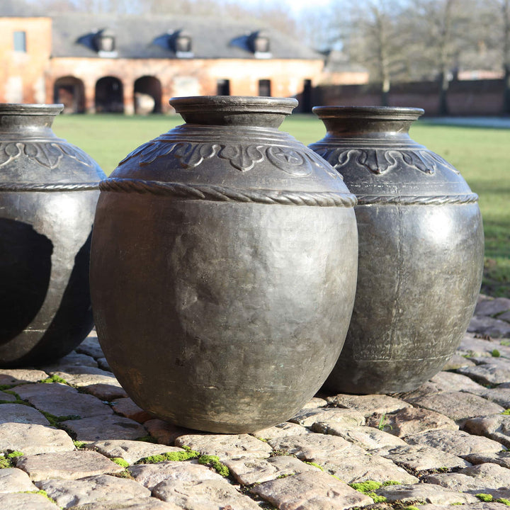 Set of four large antique Sindh bronze pots from Collection EE10, featuring intricate designs and wide openings.