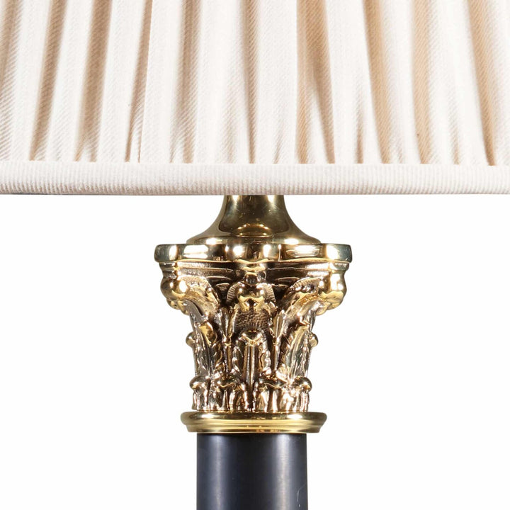 Pair of Corinthian Black Tole Column Lamp With Stepped Black Base AJ6 showing detailed gold Corinthian capital under cream shade