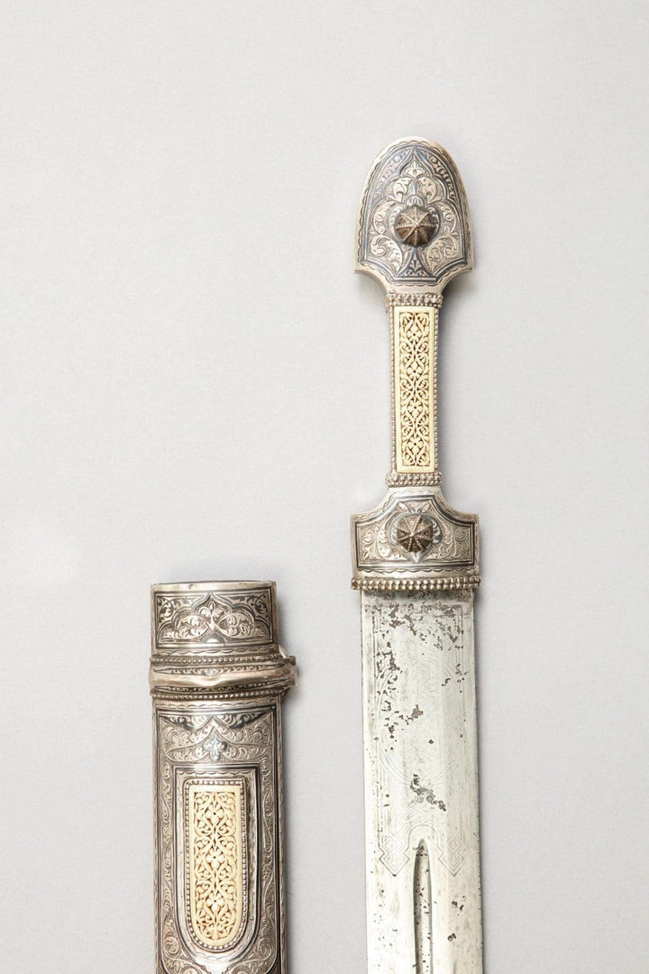 Decorative Caucasian Kindjal dagger and scabbard with intricate silver and ivory details by Nwtiques