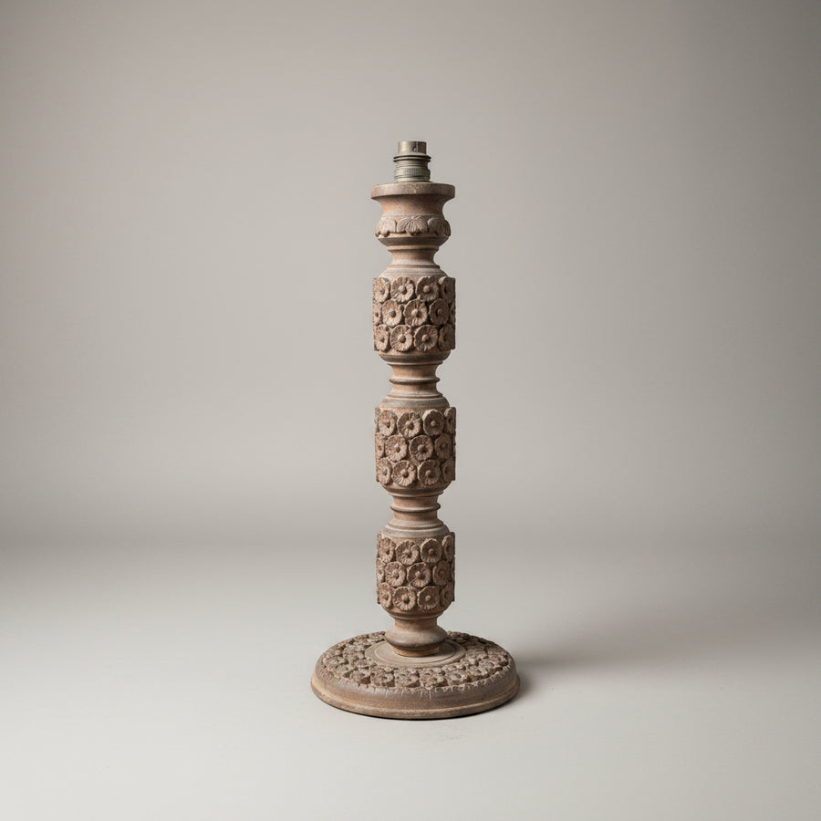 Decorative candlestick with intricate patterns on a plain background