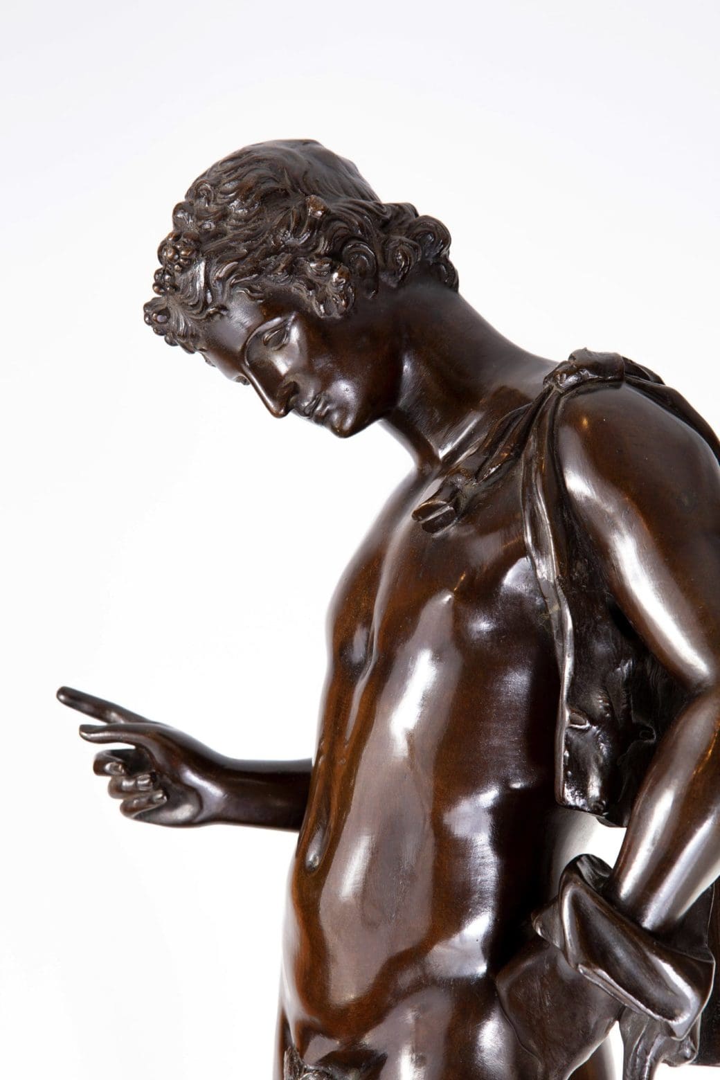 Dionysus – “Narcissus” 19th Century Bronze Statue of a male figure with black-brown patina and detailed curls.