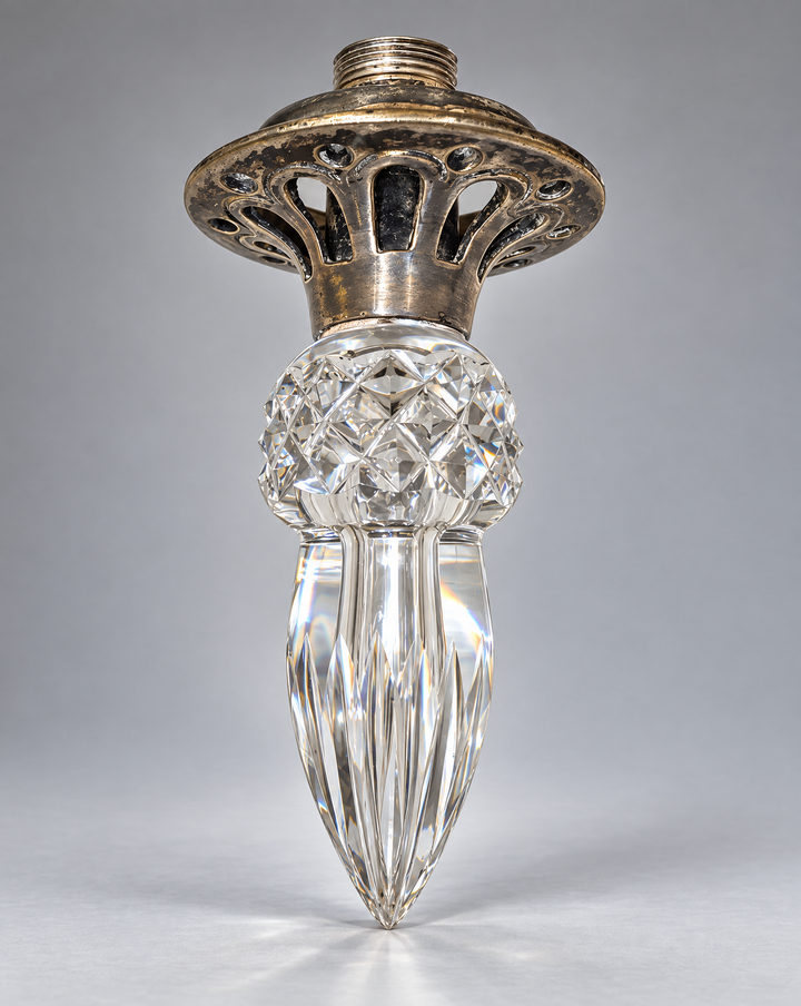 Finial with silver-toned metal mount photographed on a neutral gray background.