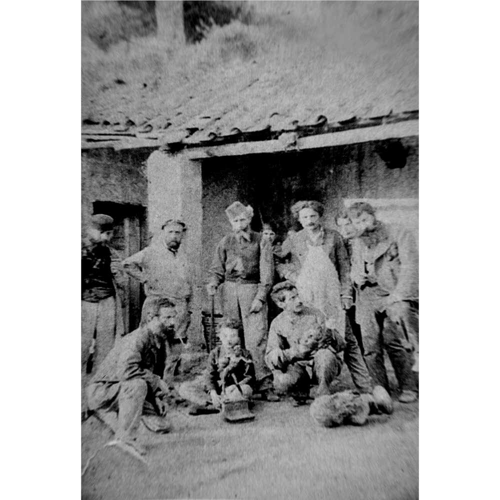 Vincenzo Gemito black and white photo circa 1888, showing men outside a foundry in Naples with sculpture Il Filosofo on ground.