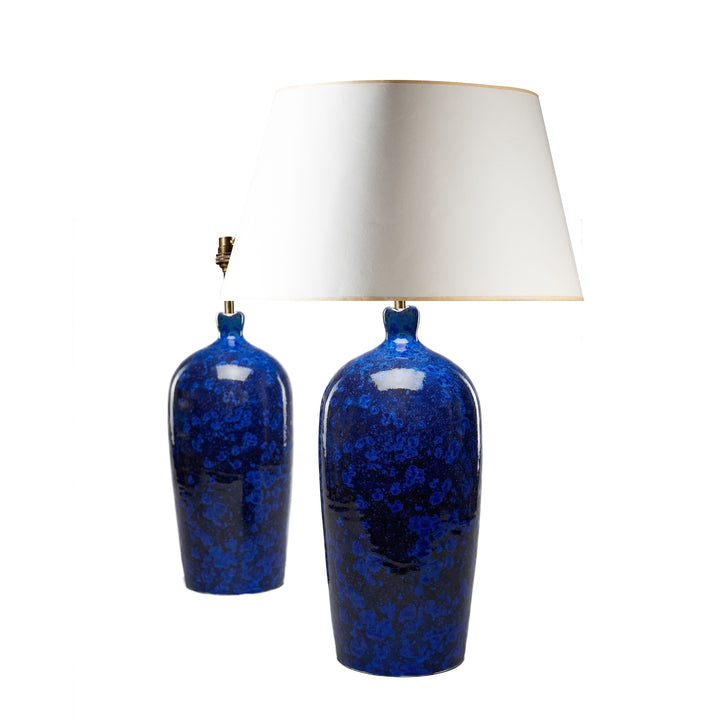 Pair of deep blue crystalline ceramic lamps with scalloped rims by Nwtiques on white background