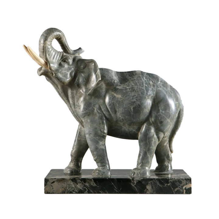 Grey Marble sculpture of an Elephant standing with trunk raised, carved from grey marble on a Portoro marble base.