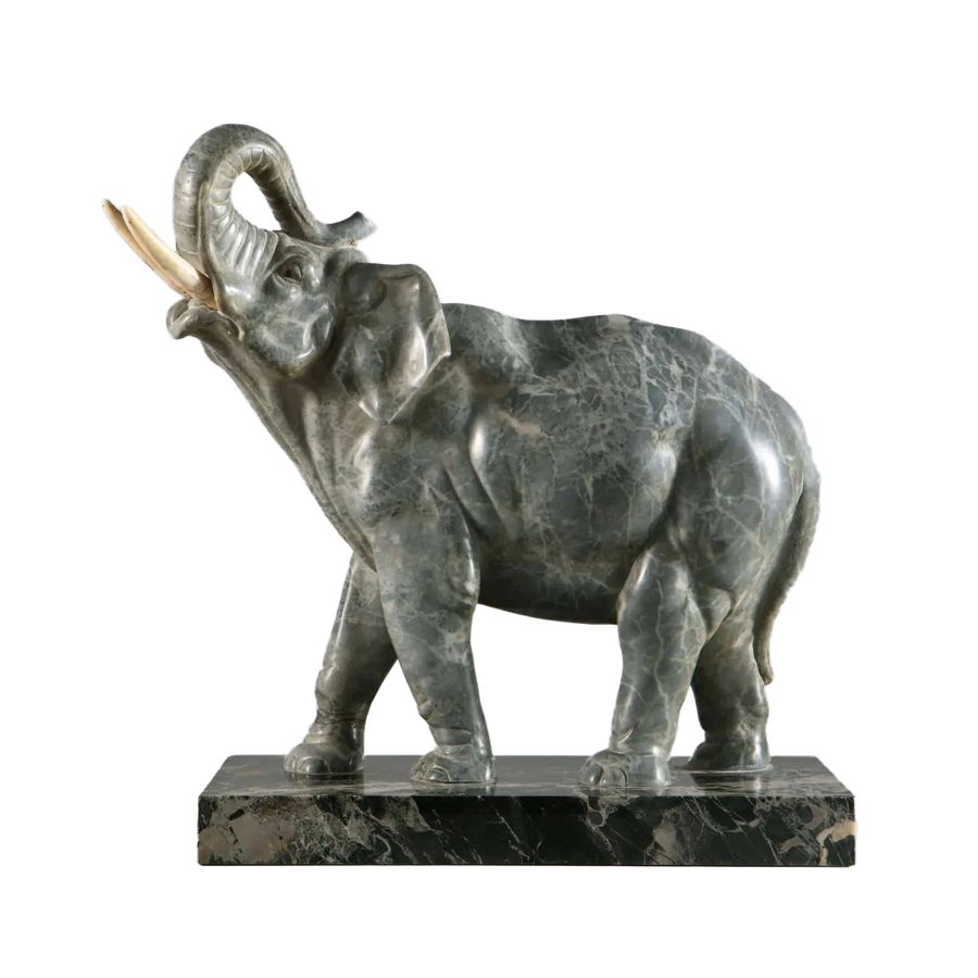 Grey Marble sculpture of an Elephant standing with trunk raised, carved from grey marble on a Portoro marble base.
