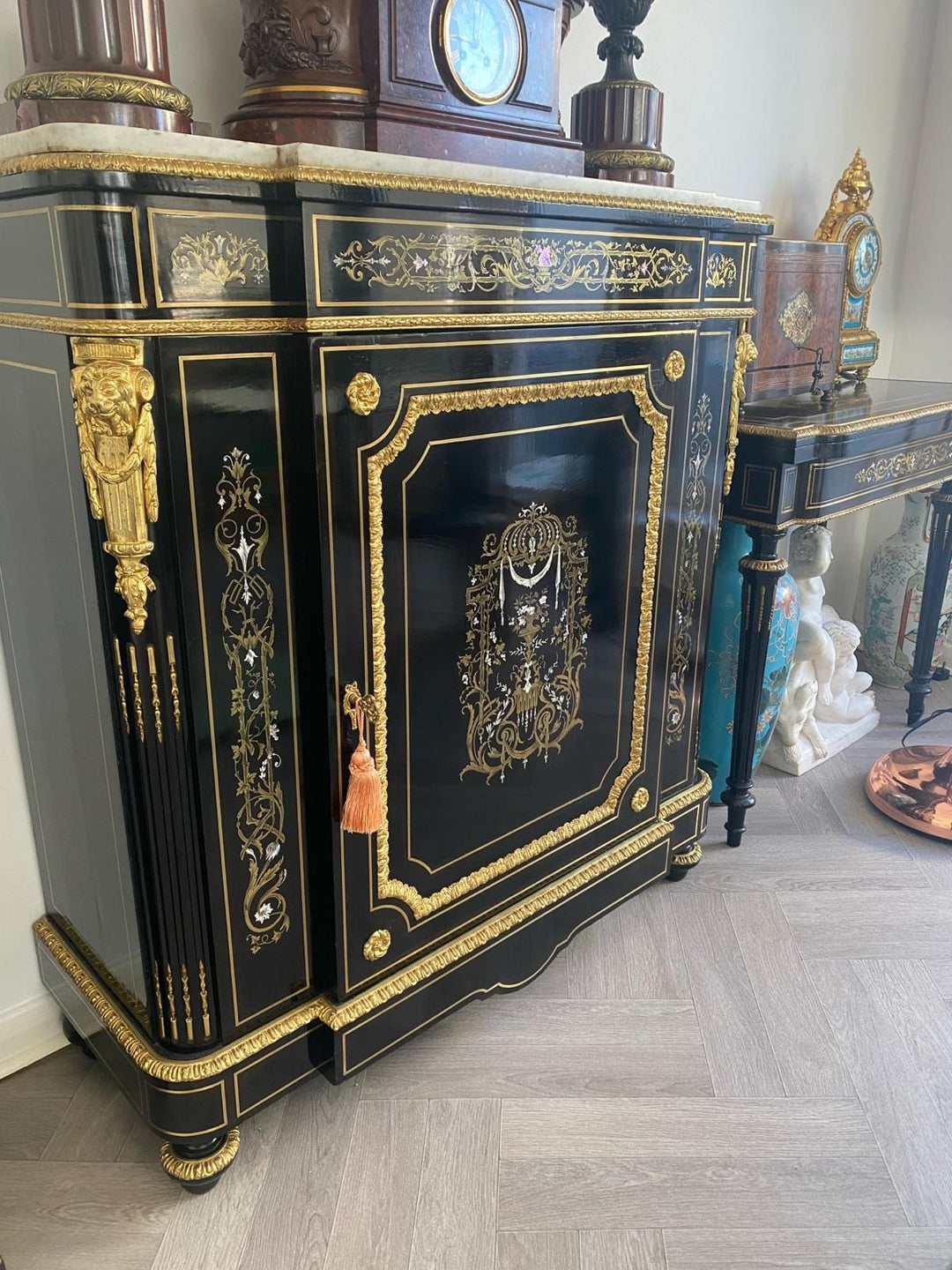 Mother of pearl inlaid ebonised cabinet with gilt bronze mounts and marble top by Nwtiques
