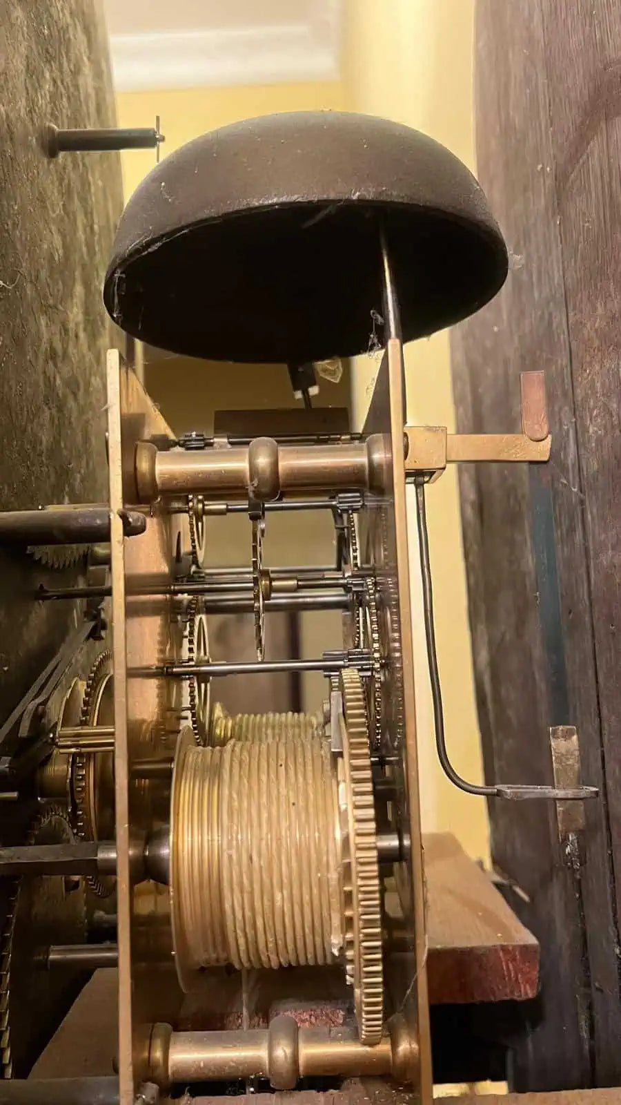 Close-up of intricate brass clock mechanism and bell from an 18th-century Sanders of Manchester by Collection PK10