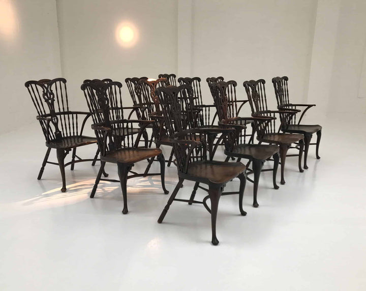 Set of 12 Georgian comb-back Windsor armchairs by Nwtiques, circa 1770, with elm saddle seats and cabriole legs