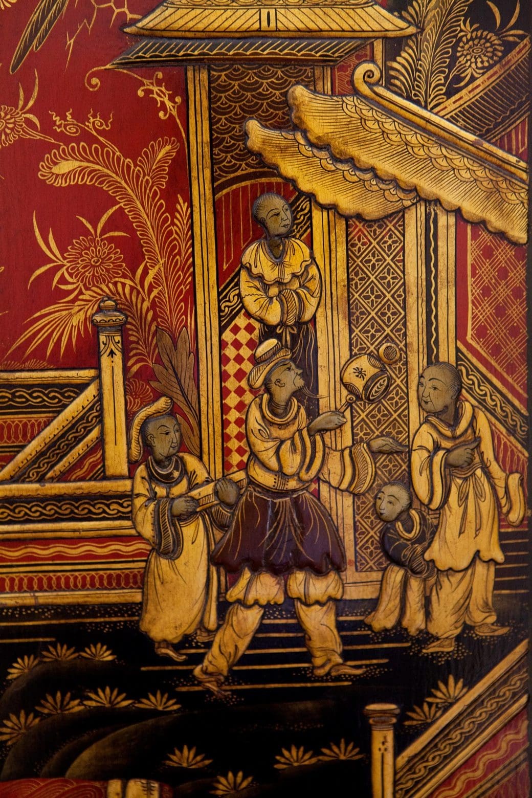 Chinoiserie scene in gold and red on Austin of Shoreditch clock from Collection TH20 displaying detailed figures and architecture.