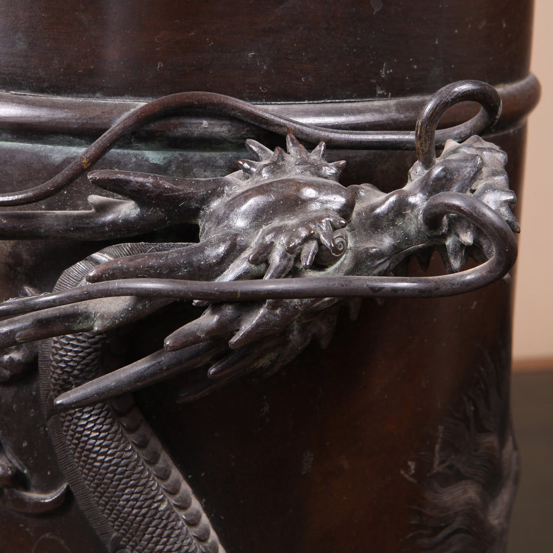 Close-up of a detailed Japanese Meiji bronze dragon on a cylindrical stick stand by Collection TH30 circa 1900