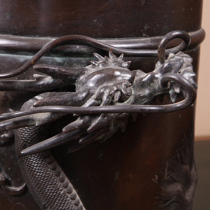 Close-up of a detailed Japanese Meiji bronze dragon on a cylindrical stick stand by Collection TH30 circa 1900