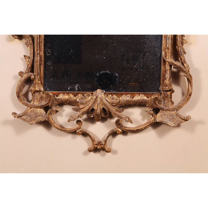 Detail of a small giltwood rococo-style George III mirror with ornate foliate carving by Collection TH30