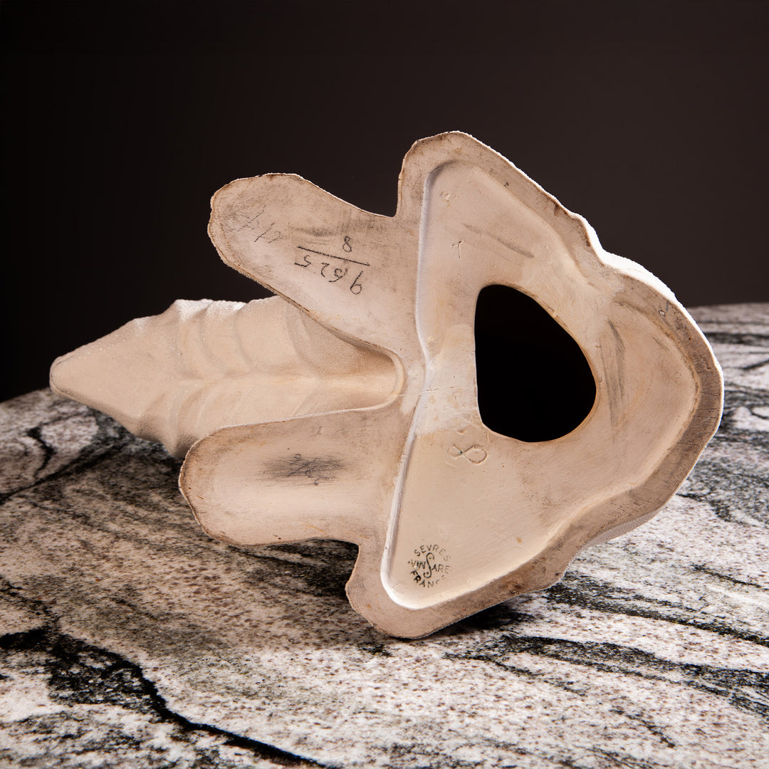 Underside of a white ceramic polar bear sculpture with shagreen enamel from Collection TH30 on marble surface