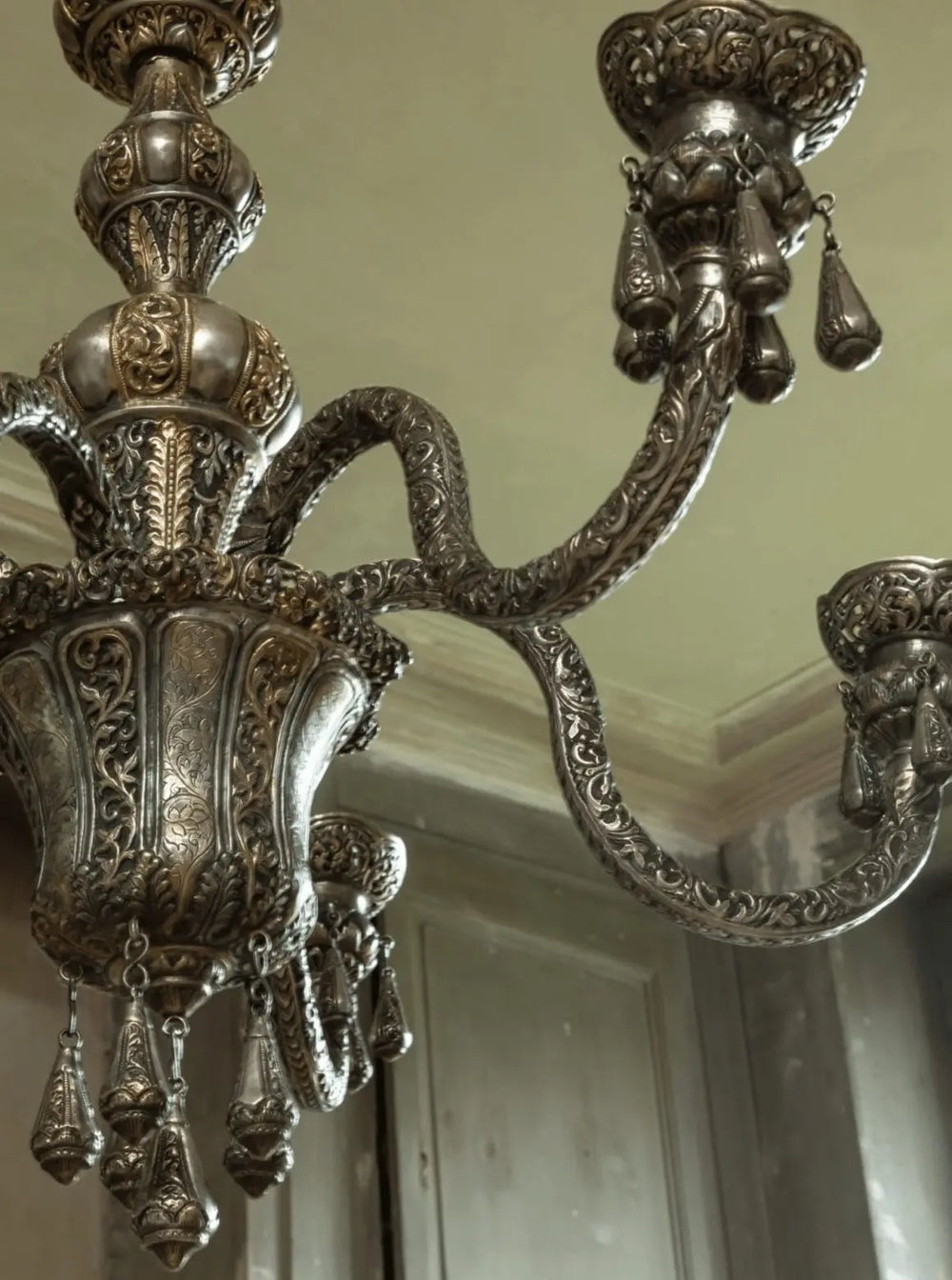Close-up of ornate Repoussé silver six arm Indian chandelier from Collection EE20 with detailed relief work