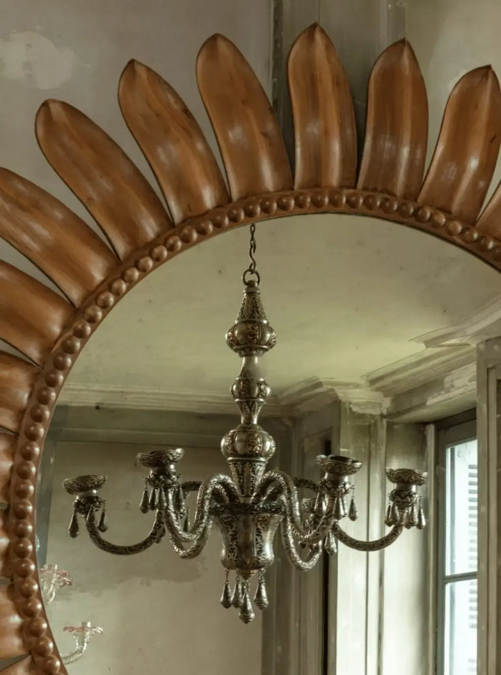 Repoussé silver six arm Indian chandelier circa 1900 hanging reflected in ornate carved wooden mirror Collection EE20