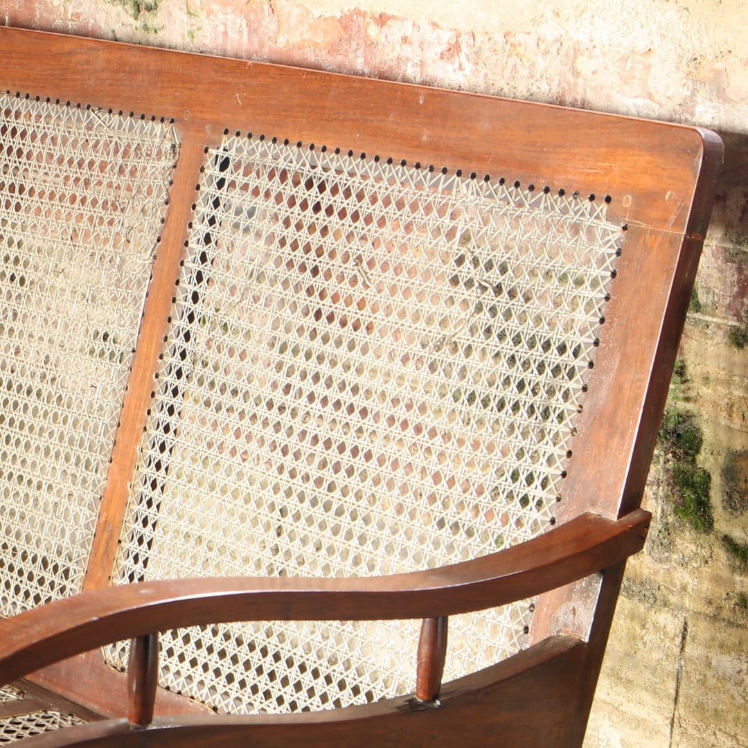 Early 20th century Bombay Art Deco settee with caned panels and Q motif arms by Collection EE20 in original condition