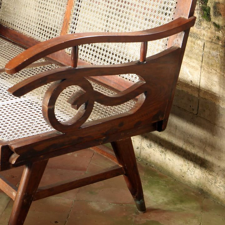 Close-up of early 20th century Bombay Art Deco settee arm with Q motif, caned panel by Collection EE20.