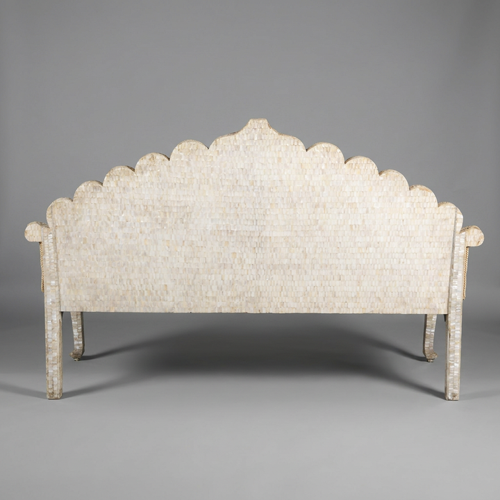 Decorative headboard with scalloped edge on a gray background