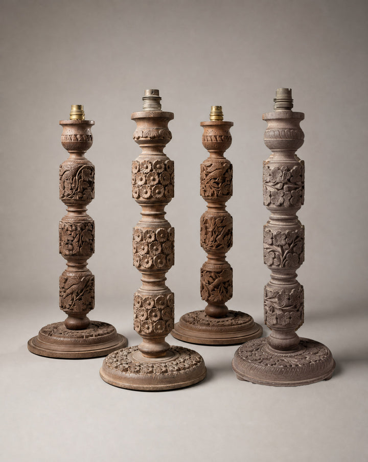 A group of four Indian carved wooden lamp bases