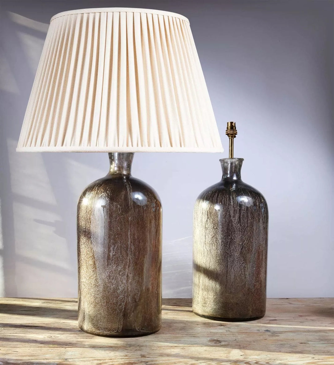 Large pair of decorative Eglomise Glass Jars at table lamps with antique silvered finish on wooden surface.