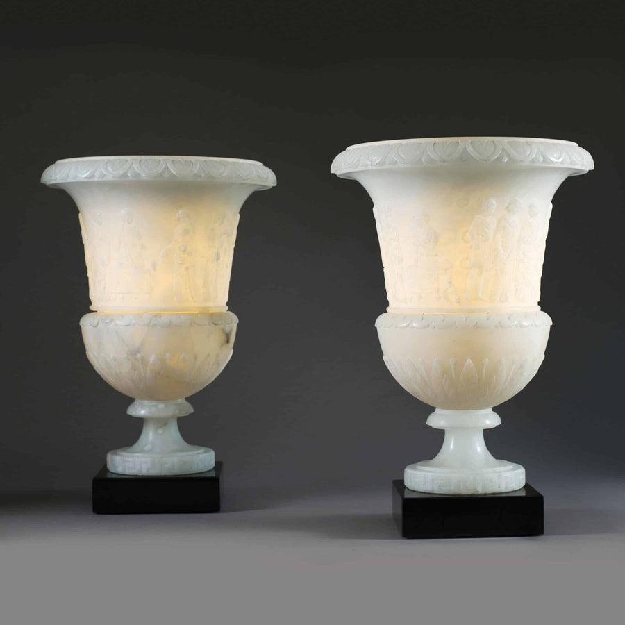 Pair of classical carved alabaster vase lamps with relief figures and black bases by The Sold Archive
