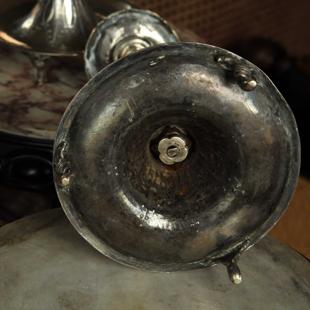 Close-up of the base of a European silver candlestick from Collection EE10 showing aged patina and detailed craftsmanship